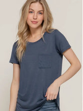 Load image into Gallery viewer, Woman wearing a blue t-shirt with a pocket on a plain background
